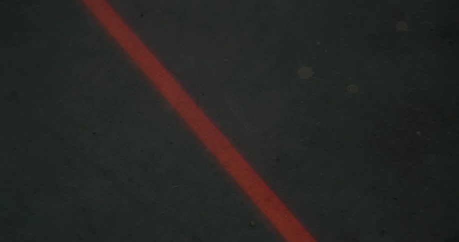 Smoke moves over an orange line on the pavement