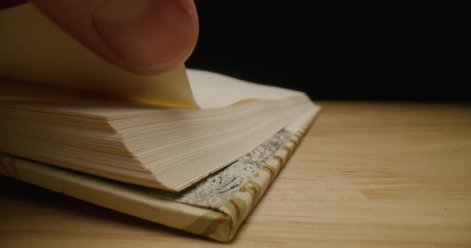 Someone turns the page of a book