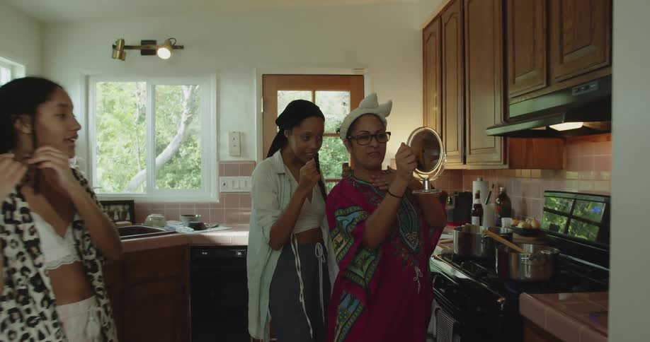 A family is gathered around the kitchen together