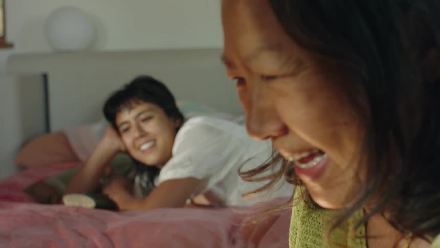 Two women are in a room and laughing together