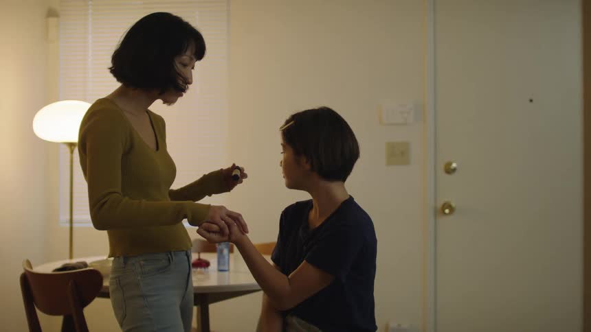Two women are in a room together and talking