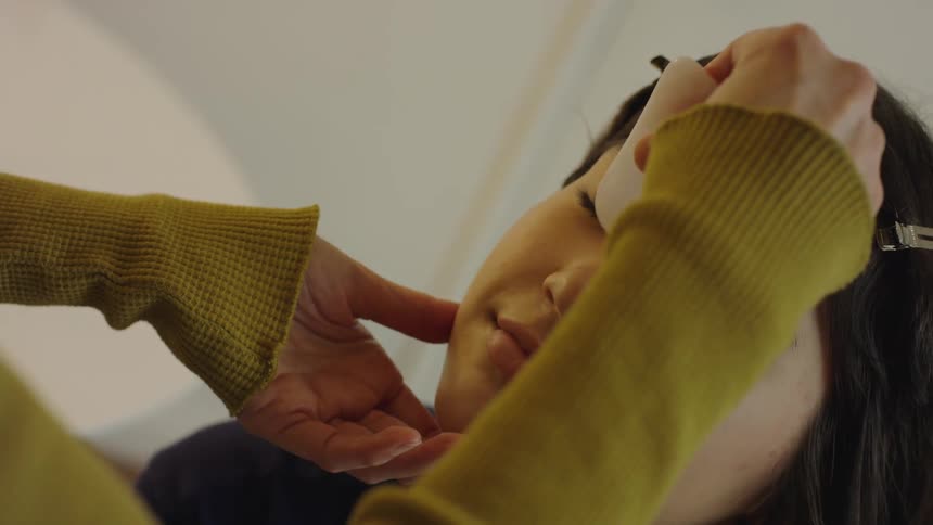 A woman is receiving a massage on her face