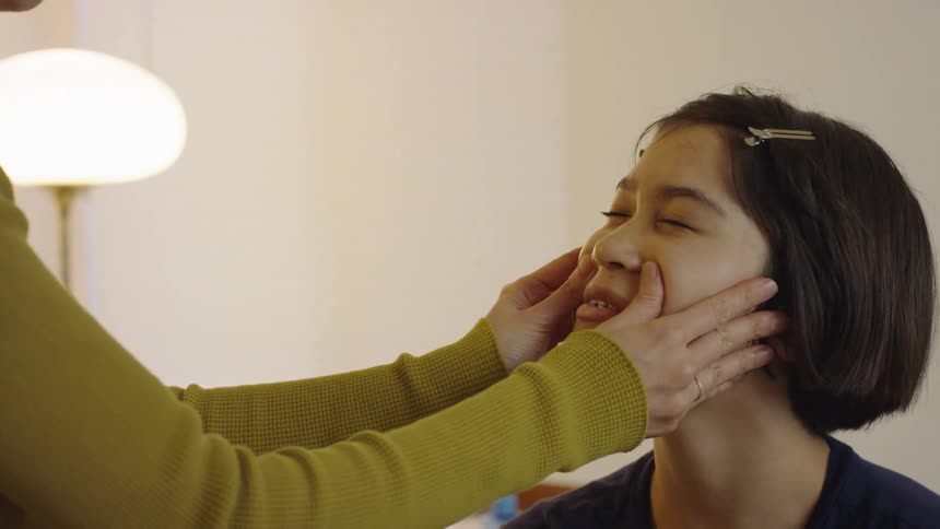 A woman applying cosmetics to another womans face