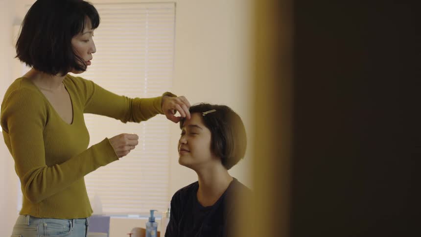Older woman fixes younger womans hair