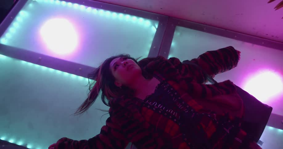 A woman is laying on the ground and relaxing