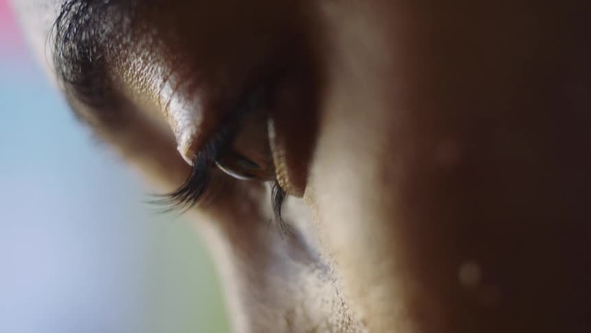 Close up of a womans face as she looks down at the ground