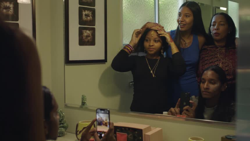 Family takes a group pictures with a smartphone on the bathroom mirror