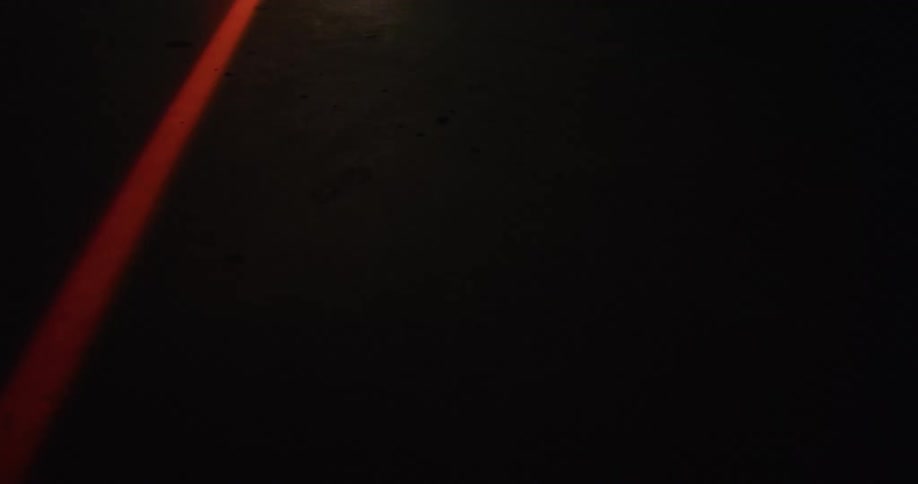 A red light is flashing outdoors at night