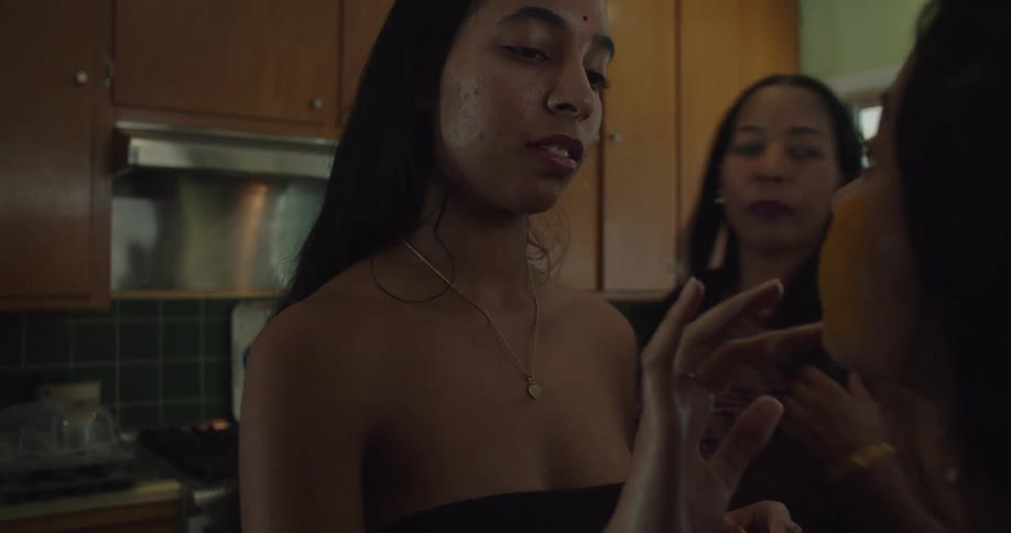 Young happy girl applying makeup on a friend in the kitchen at home
