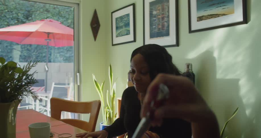Teenager sits at the table with her friends at home