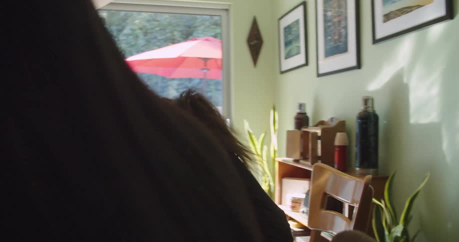 Group of girls talking and laughing in the dinning table on the kitchen at home
