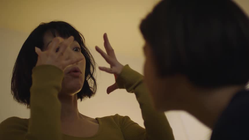 Two women are talking as they apply makeup