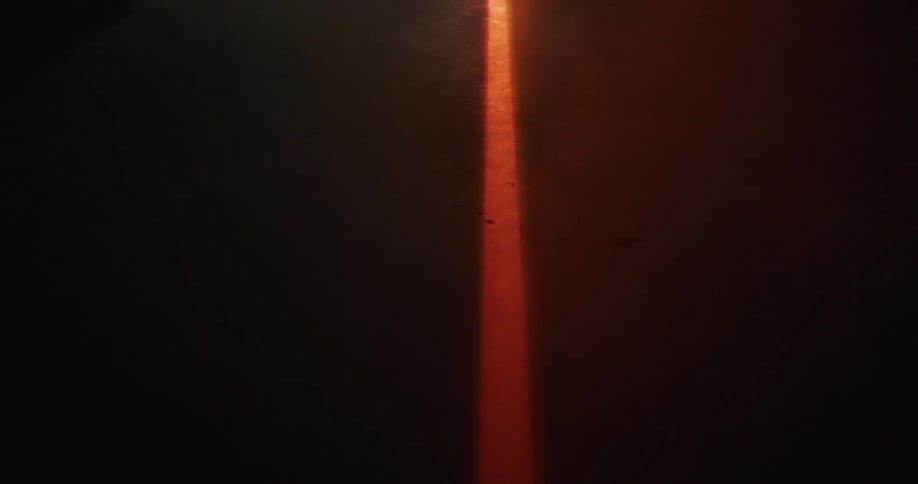 Smoke moves over an orange line on the concrete