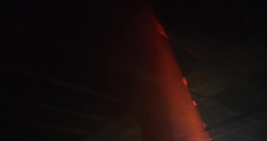 A light flashes into the dark room