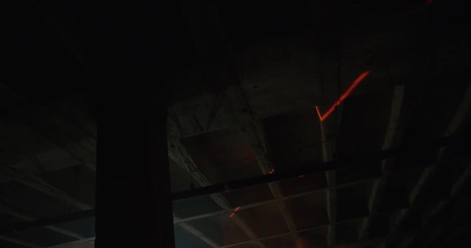 A light beam moving across a ceiling in a building