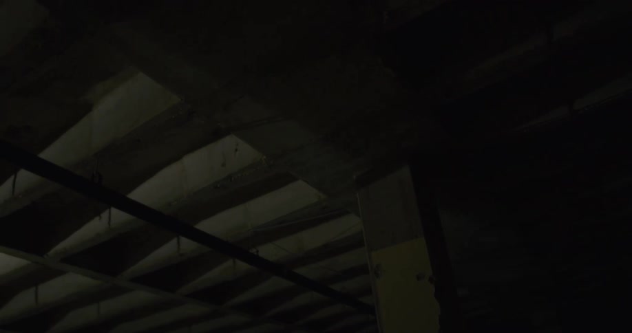 A laser shining on the ceiling of a dark room