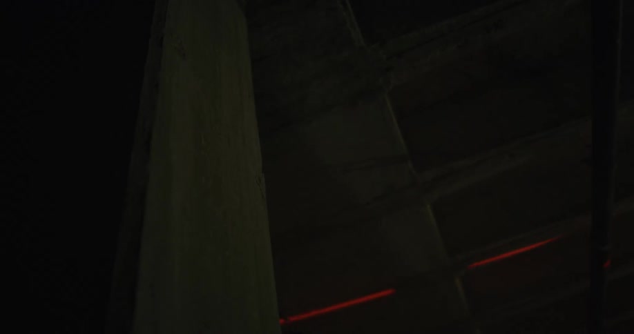 A red laser shining on the ceiling of a dark room