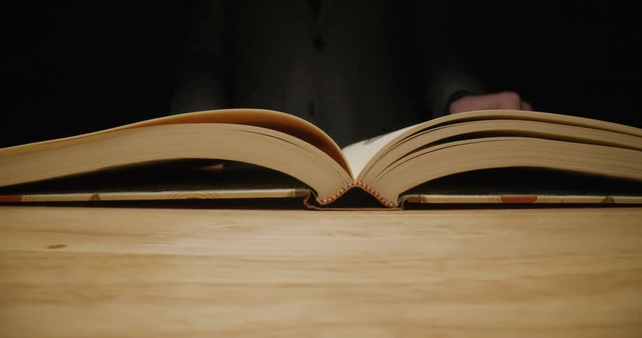 Person flips open book and pages through it