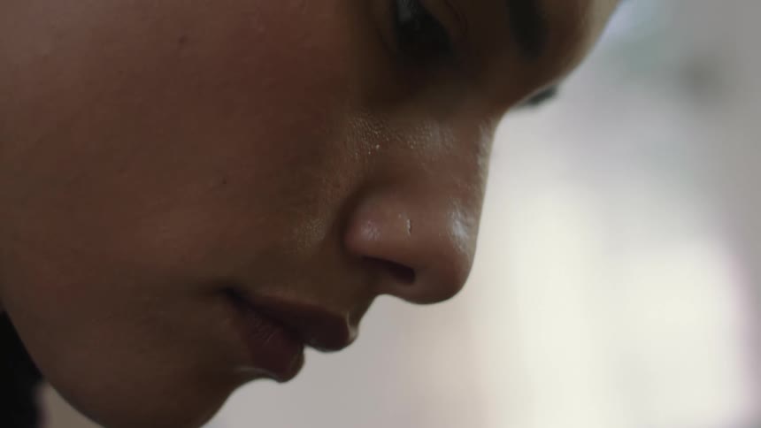 A womans face in profile with skin and pores clearly visible