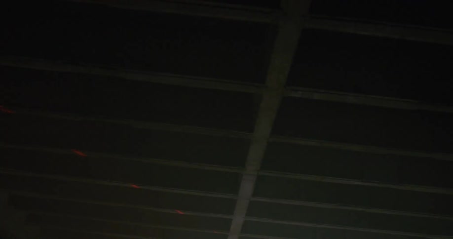 Pinpoint of lights flash across wooden beams