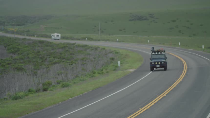 Vehicles drive on a rural road