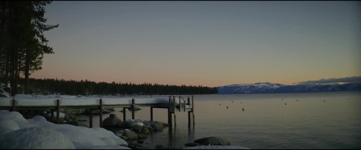The pier is covered with snow at sunrise
