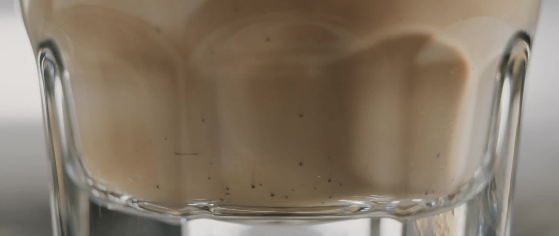 Cream slowly moves to the bottom of a coffee cup