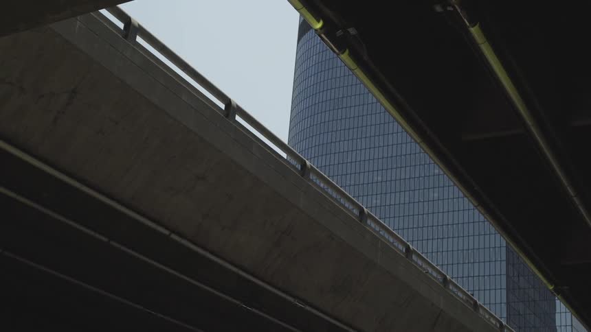 A building can be seen from under an overpass