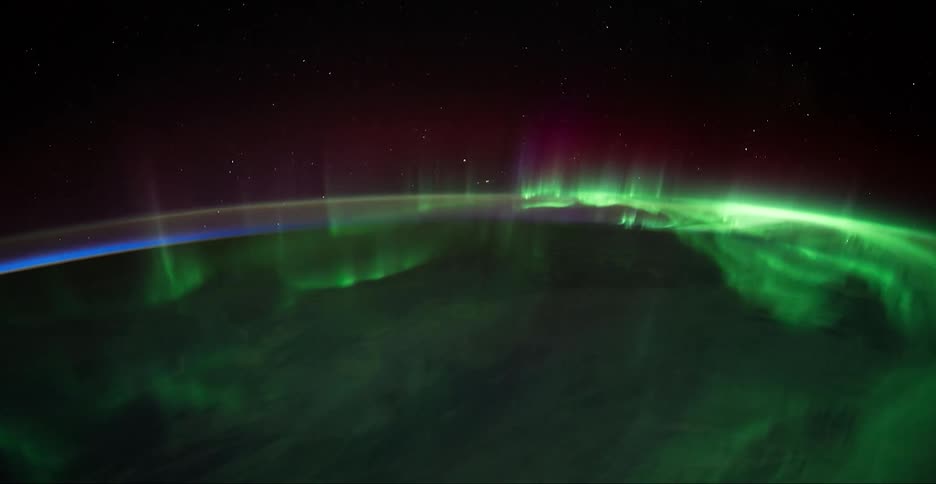 An aerial view of glowing northern lights at night