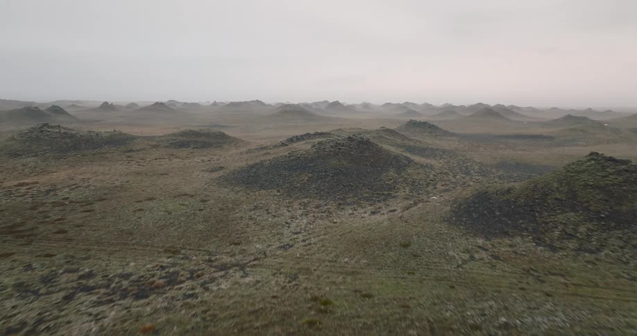 Mountains rise up from grassy plains