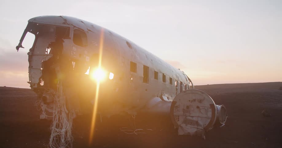 The sun sets over wreckage from a crashed airplane