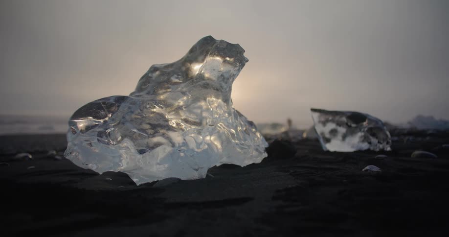 Sunlight shining down on chunks of ice on the ground in nature