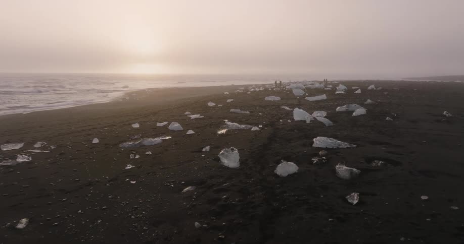 Ice is covering the coast of the beach at dusk