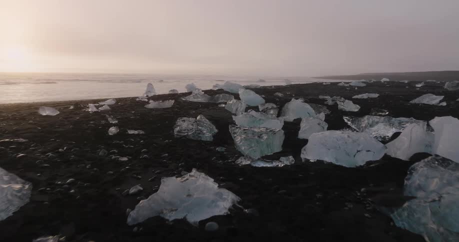 Ice is covering the beach at dusk