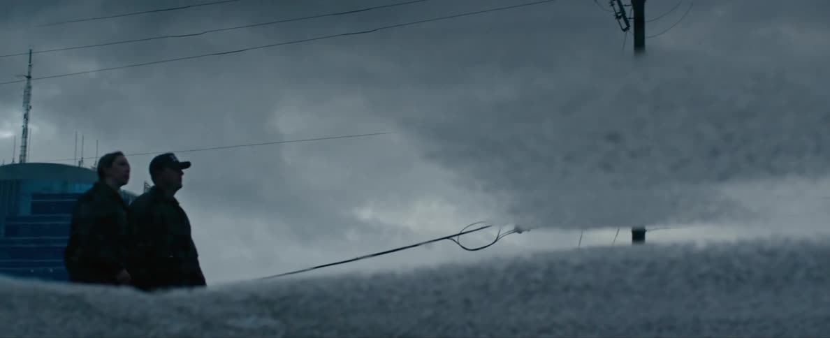 Two men are walking in a rural area in winter