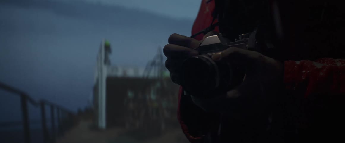 Person wearing a red jacket takes pictures with a vintage film camera outdoors