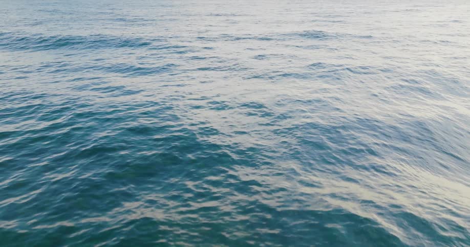 Ocean water moves and ripples as waves roll in