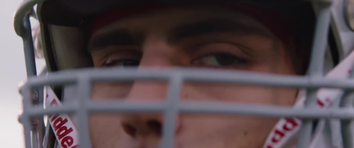 A young football player wearing a helmet and mouthguard