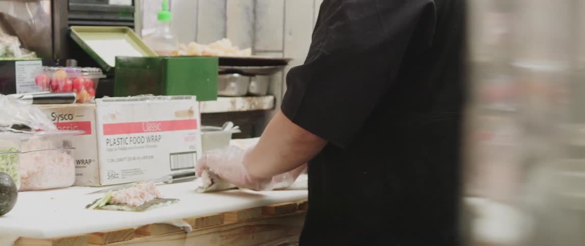 A chef preparing food on a restaurant kitchen counter