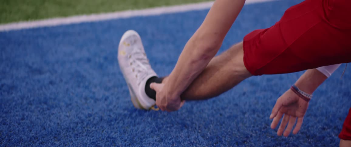 Football players wearing football uniform stretches
