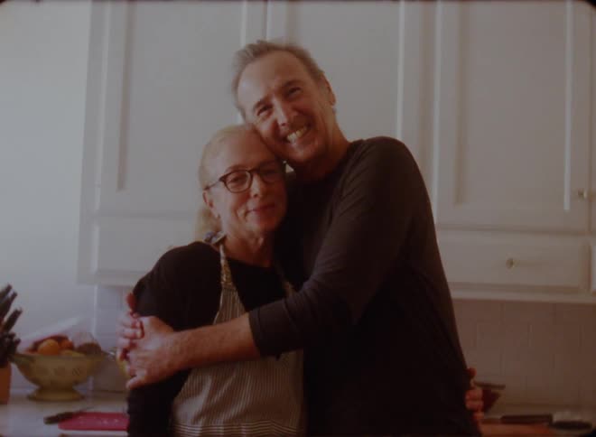 Man and woman are hugging in the kitchen together