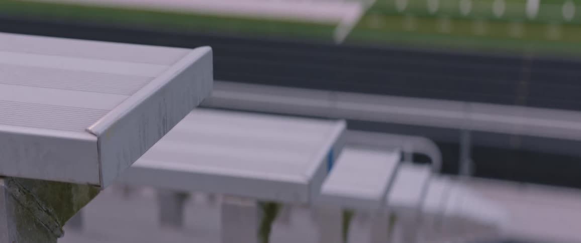 The bleacher seats in an outdoor sports stadium