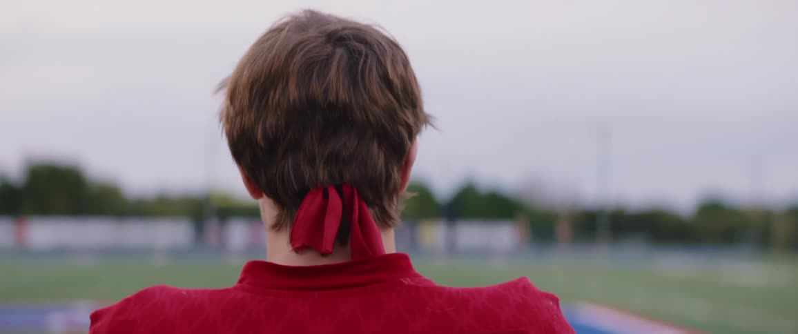Young football player walking on a stadium at evening