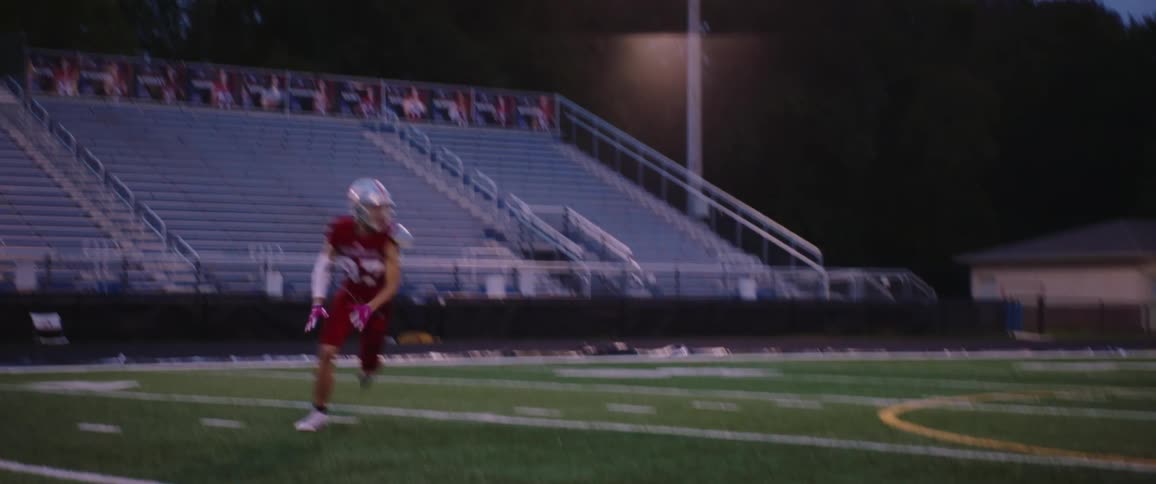 A football player races to catch the ball