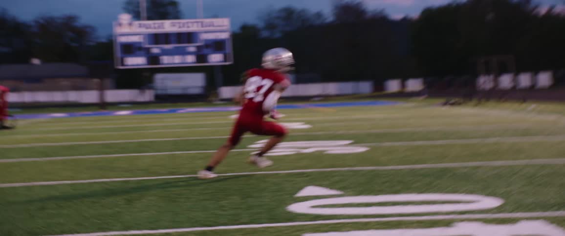 Football player trains running down field and turning to catch football