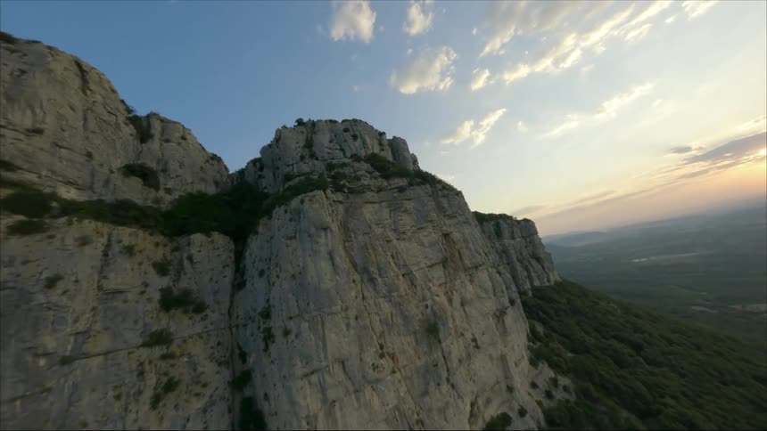 An aerial view of a mountain range as the sun sets
