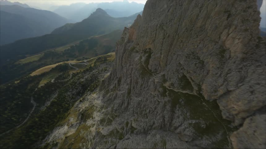 An aerial view of a tall rocky mountain ridge in the wilderness