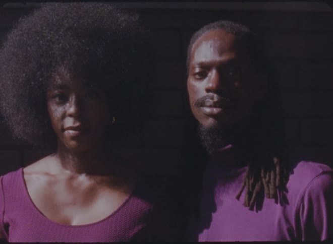 Two people are posing for the camera next to each other