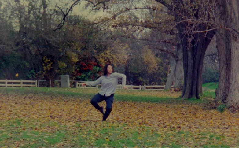 A woman is dancing in the leaves
