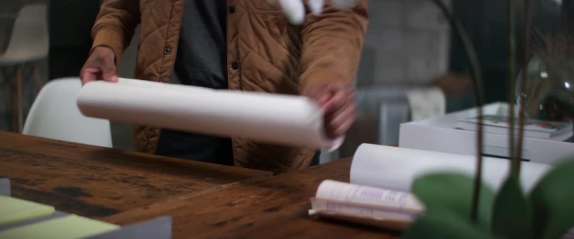 A person is folding up a piece of paper in their office